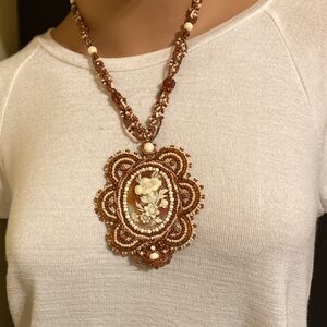 Artisan hand beaded pendant necklace featuring framed floral cameo style